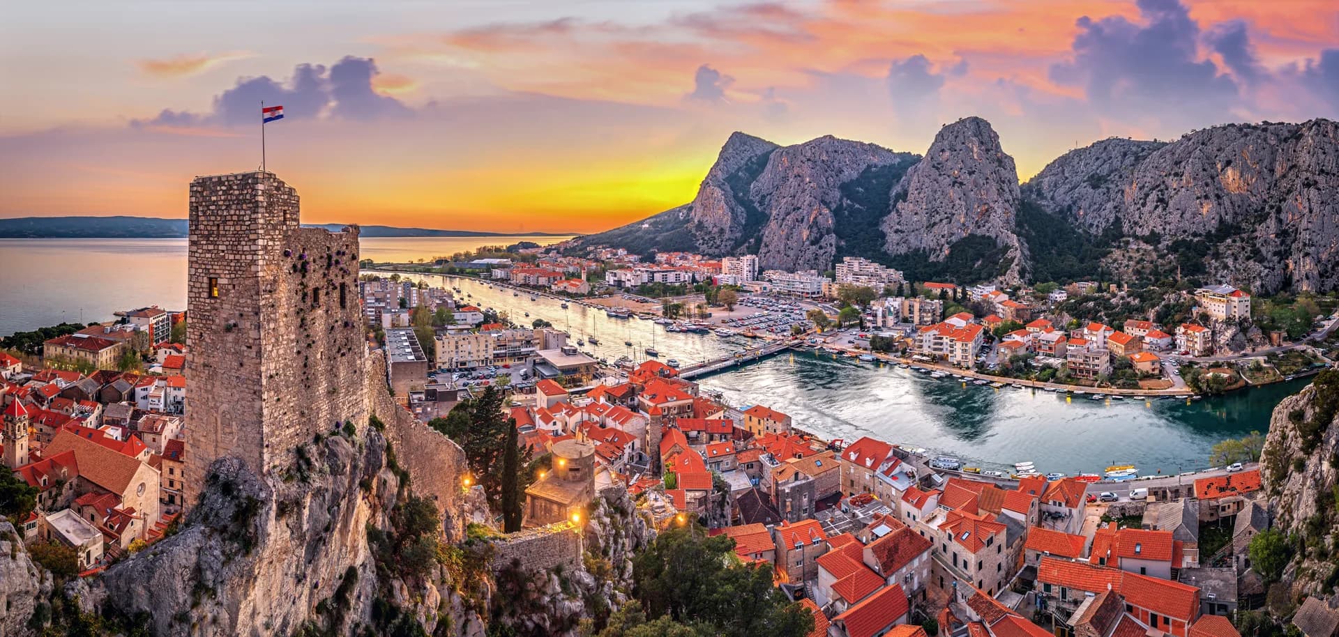 The river meets the sea at Omiš, beneath steep limestone mountains.